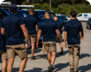 Plumbers walking to their service vans on a Mascot job